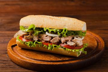 Delicious tuna sandwich, served with lettuce, tomato and onion.