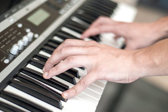 Hands of a male keyboard player