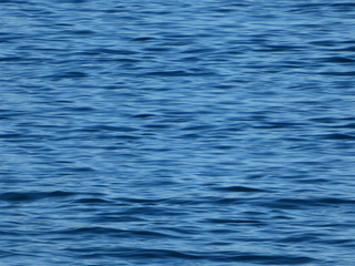 Ripple water background. Deep blue sea water surface texture