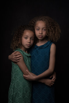 Studio portrait of two sisters