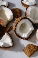 Close up image of cracked coconut on gray background