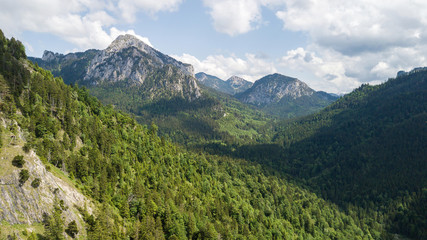 Fototapeta na wymiar View from a height to a mountain range with coniferous trees