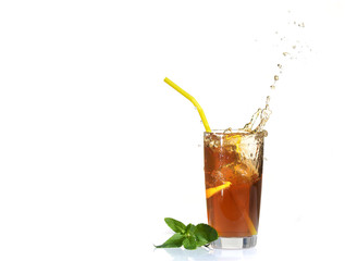 Splashes from a glass of cold tea with lemon.