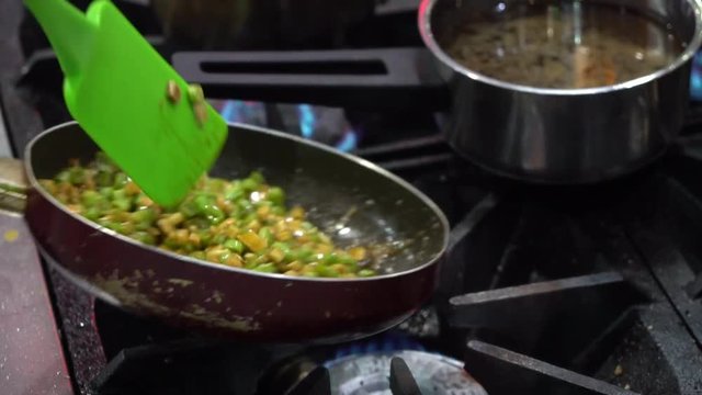 The Chinese food cooking process,stir the vegetable and ingredient in the pan in slow motion scene.