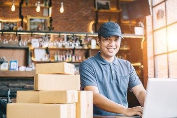 Online shopping young start small business in a cardboard box at work. The seller prepares the...