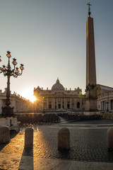 Tourists in St. Peter's Square, Vatican City (a city-state surrounded by Rome). Photo was taken at sunset