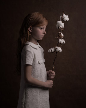 Studio portrait of holding cotton plant