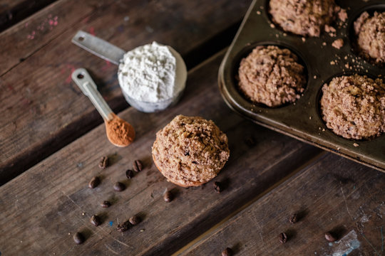 Mocha muffins and ingredients on a rustic wooden table