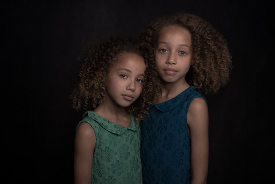 Studio portrait of two sisters