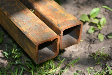 Metal profile with rust and corrosion for construction rusty in the shade with sun rays on the screech