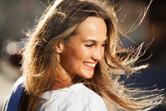 Beautiful happy woman with flying hair