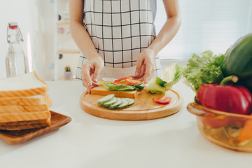 Woman apron preparing a breakfast in the kitchen