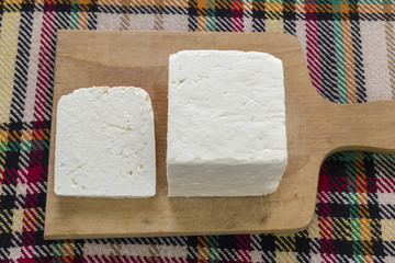 Cutting traditional bulgarian white cheese
