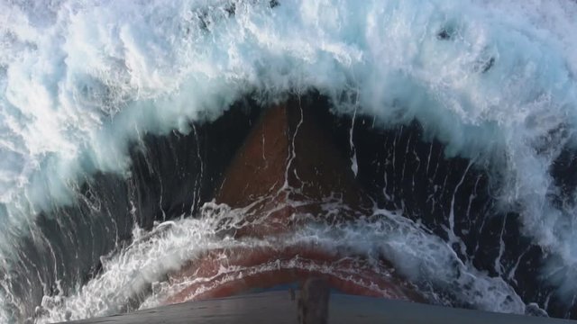Foamy splashes of a sea wave against ship's bow - slow motion.