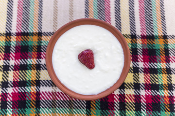 Strawberry in a bowl of yogurt