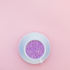 Cup of beautiful lilac flowers infused water