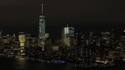 Fototapeta na wymiar AERIAL: Skyline of World Trade and Financial Center complex lighted at night