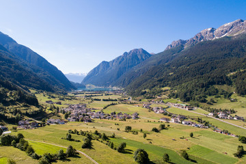 Fototapeta na wymiar Valposchiavo, lake of Poschiavo and alpine villages. Swiss Alps