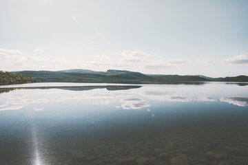 Lake Kilpisjarvi Landscape in Finland with Mountains and clouds mirror reflection Summer Travel scenic minimal view