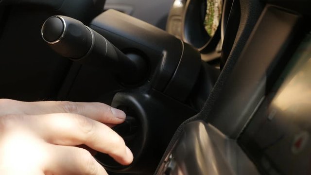 Close-up inserting of ignition key into swich slow-mo footage