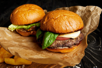 Hot burgers and french fries served on craft paper