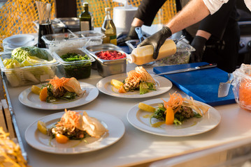 A cook preparing dishes from fish on fish market