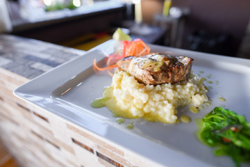 A fish steak dish with potatoes puree