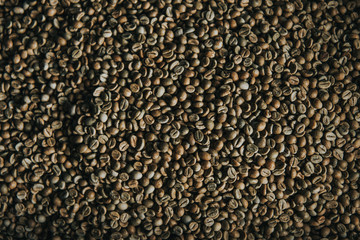 Raw coffee beans in process of roasting texture