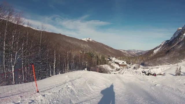 A skier skiing on the tracks in mountains, gopro footage