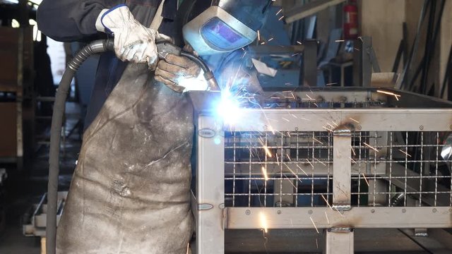 Metal Welding with sparks and smoke in manufacturing