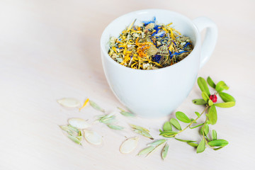 Differet dry health herbs and flowers in glasses