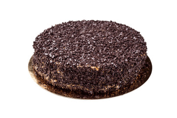 Dark chocolate vegan cake with candies and nuts isolated on white background