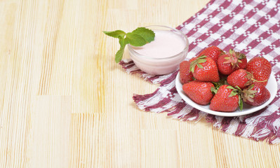 A pure appetizing strawberry on a white plate