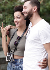Naklejka premium Cheerful young couple walking on urban street