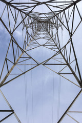 Electricity tower seen from below and blue sky.