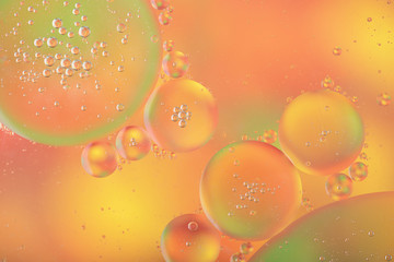 Abstract colorful background with macro of oil drops on water