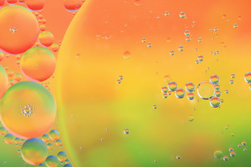 Abstract colorful background with macro of oil drops on water