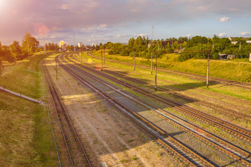 Fototapeta na wymiar Aerial view on Railway tracks against beautiful sky at sunset. Cargo shipping. Travel background