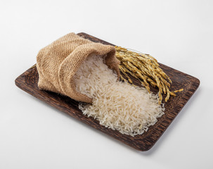 asmine white rice in small burlap sack on wood