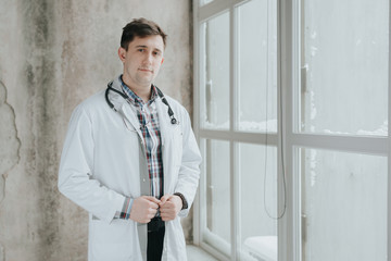 Portrait of confident young medical doctor. Young doctor man with stethoscope.doctor in a medical dressing gown