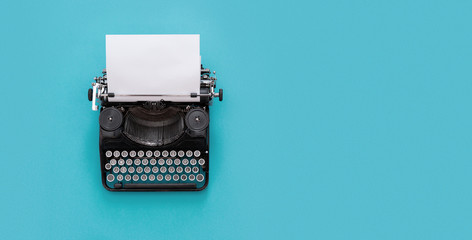 Vintage typewriter over blue background with copy space