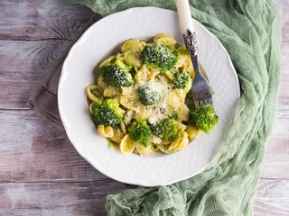 Printed roller blinds meal dishes Orecchiette pasta with broccoli in white dish on wooden table. Easy recipe for lunch.