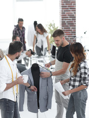 group of designers discuss men's suit