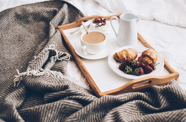 Traditional romantic breakfast in bed in white and beige bedroom - obrazy, fototapety, plakaty