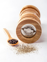 Pepper mill on a white isolated background with peppers