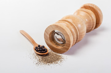 Pepper mill on a white isolated background with peppers