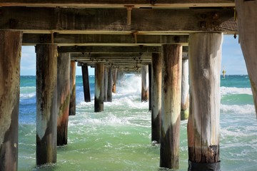 Waves under the bridge. Seaford pier.Australia