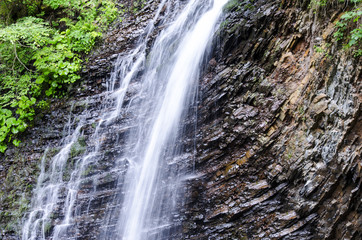 Fototapeta na wymiar Waterfall of mountain river