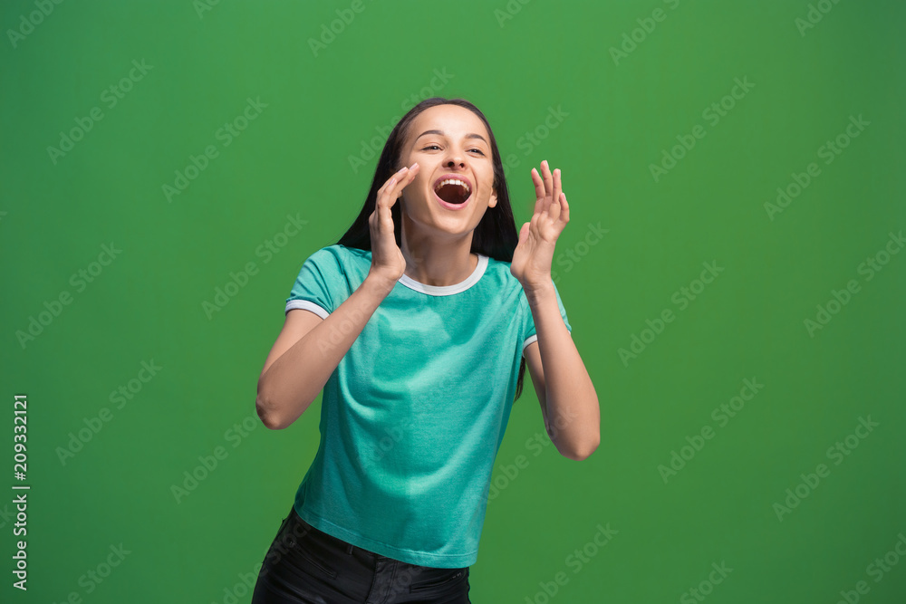 Wall mural Isolated on pink young casual woman shouting at studio