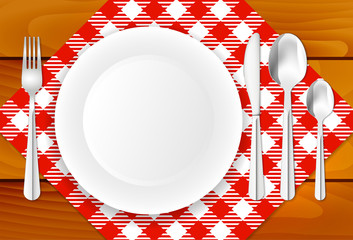 Wooden table, cloth, plate and stainless cutlery